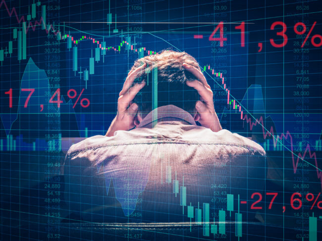 Börsenkursabsturz verzweifelter Mann im Vordergrund